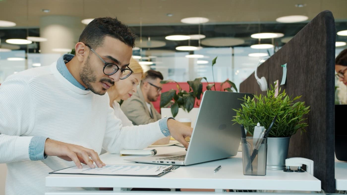 Balance scale weighing CISM exam costs and study time against a security management job title